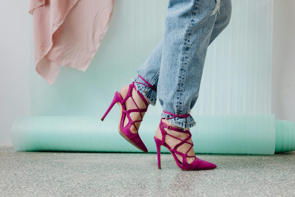 high heels for women jeans and vibrant pink stilettos, embodying modern style.